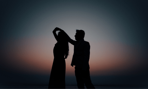 Silhouette of a husband and wife dancing at sunset, symbolizing love, forgiveness, and healing in marriage through faith.