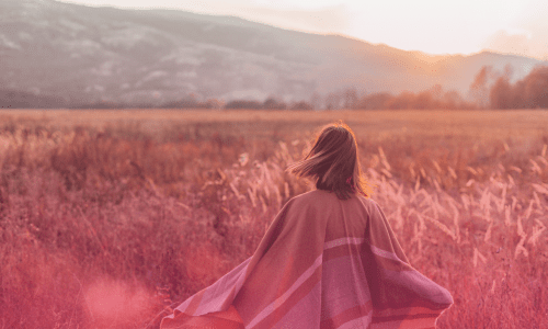 Woman walking in a sunlit field, symbolizing renewal, strength, and God’s grace — 'Grace for the Days You Want to Give Up.'