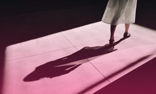 Shadow of a woman walking toward the light, illustrating 'Trusting God Thru Shift